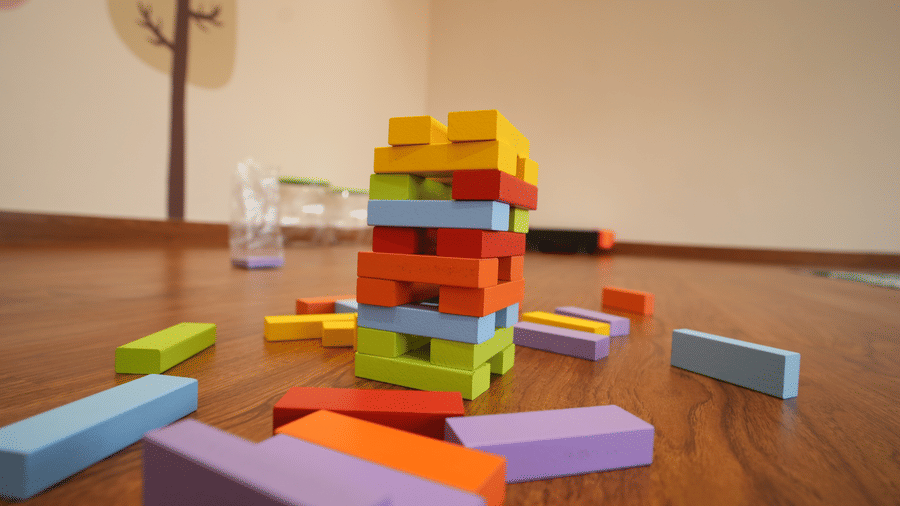 A colourful puzzle set stacked on a wooden floor at Kadamb Kuteer, Vrindavan