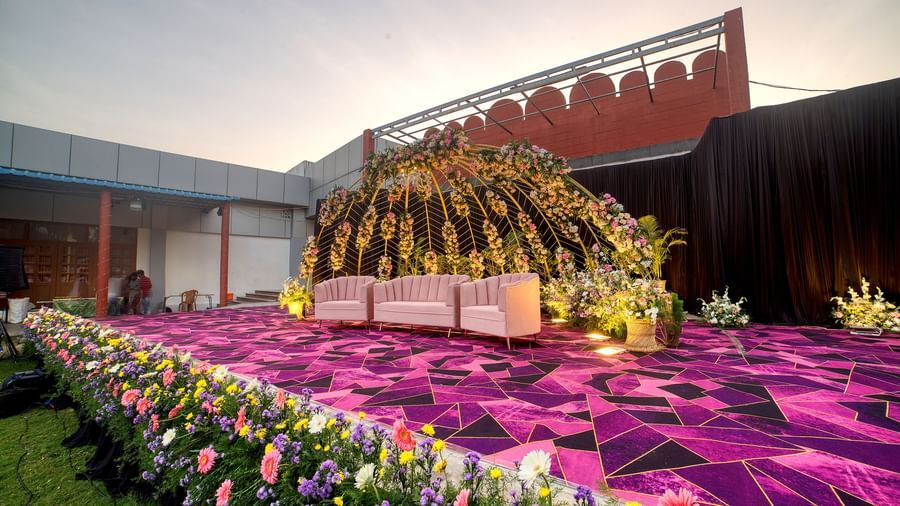 Floral-themed outdoor stage setup ideal for weddings and ceremonies at Kailash Conventions ECR.