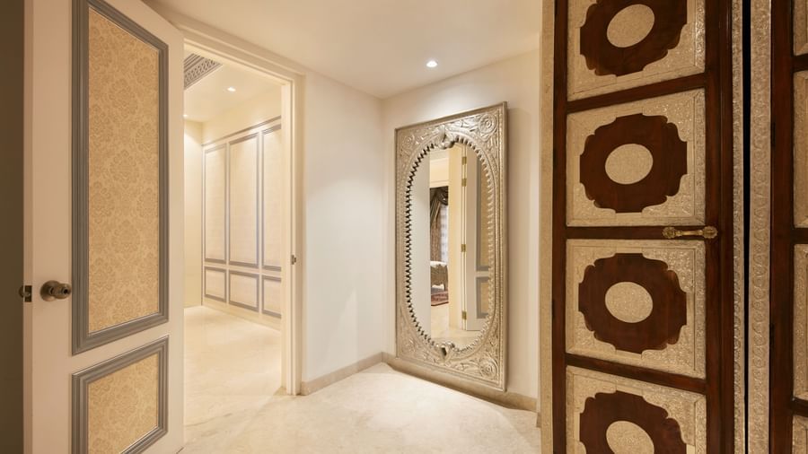 A lavish hallway entrance with carved wooden panels and soft ambient lighting - Kaldan Samudhra