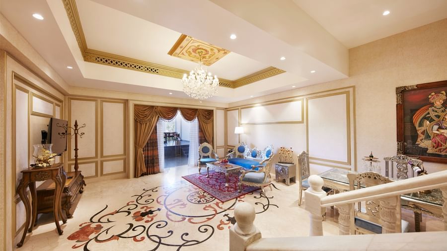 A grand living area with a colourful rug and sophisticated beige furniture - Kaldan Samudhra