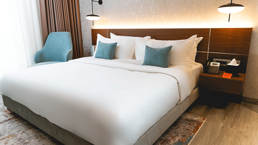 An overview of a bedroom with plush bedding inside two bedroom suite - KertelSuites, Kinshasa