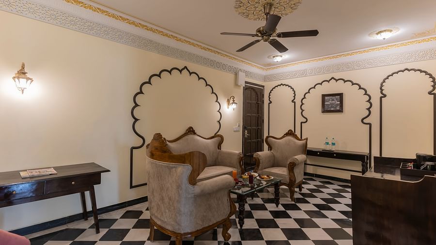 Royal-style living room with sofas and black-and-white flooring at Kesar Bagh Palace.