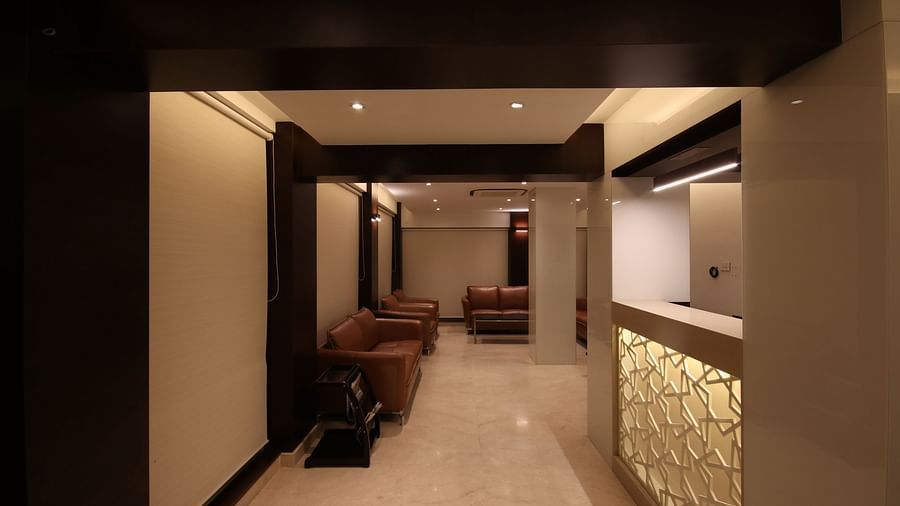 lobby area with comfortable chairs and warm lights at Khanna Fiesta, Vellore