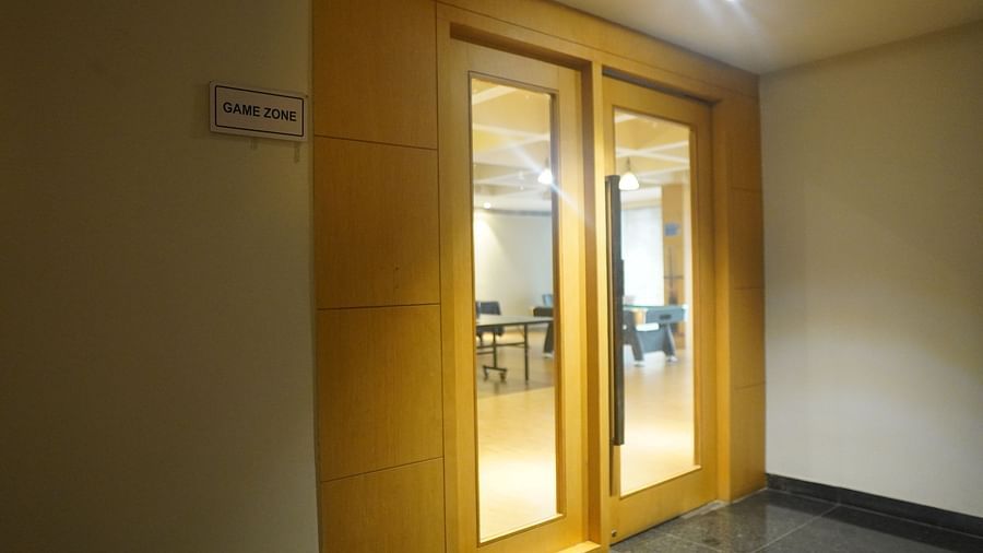 Entrance of the kids play zone featuring large glass doors.