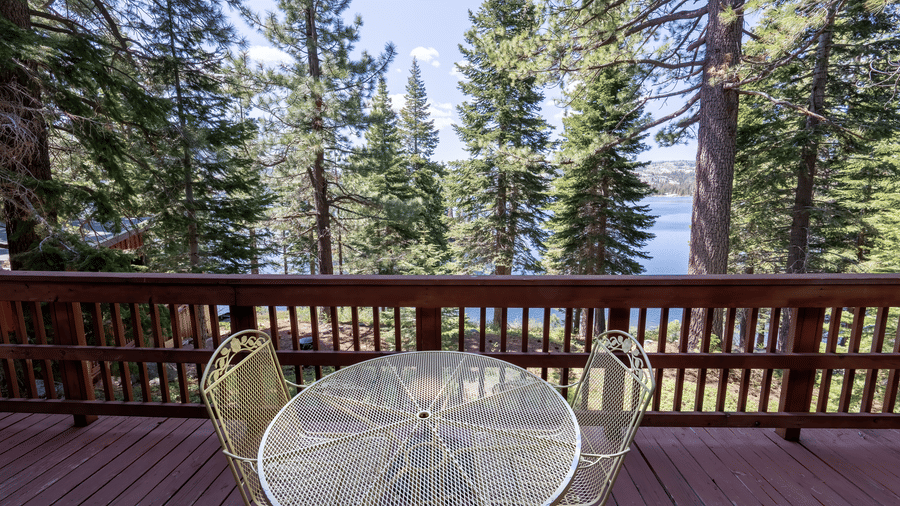 Outdoor patio with round table and forest views providing a peaceful setting at Kit Carson Lodge.