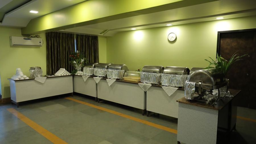 Buffet section at Krushnai Resort with multiple chafing dishes and a countertop.