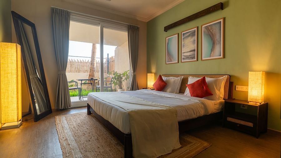 Bright and airy bedroom with double bed, contemporary decor, and access to balcony at Kssemya.