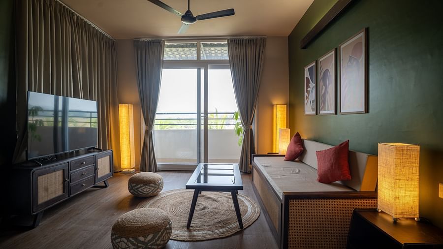 Stylish bedroom with modern furnishings, soft lighting, and balcony access at Kssemya.