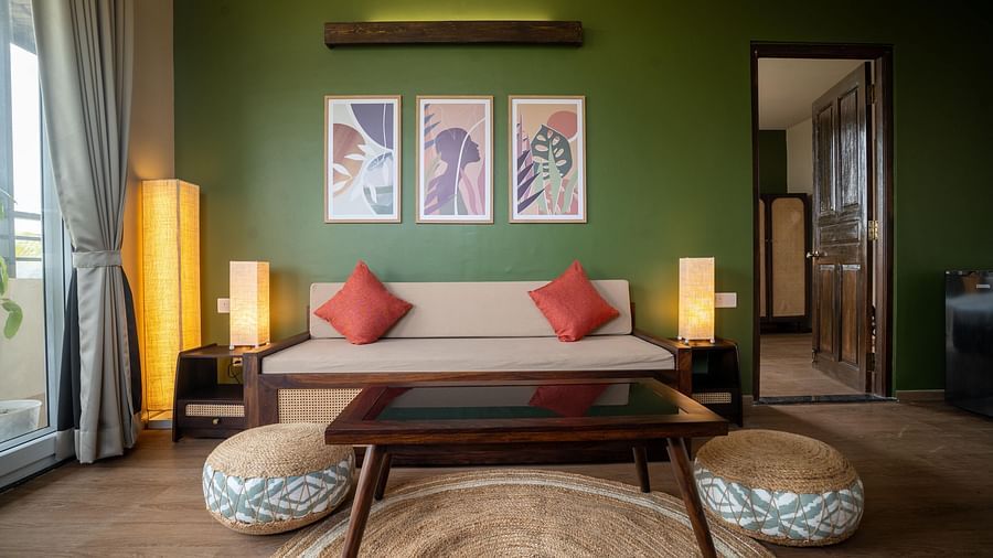 Chic living area with a wooden coffee table, pouffes, and contemporary wall art at Kssemya.