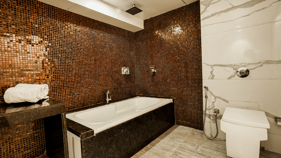 Bathroom featuring a bathtub and modern fittings at Kumar Resort by Turtle.