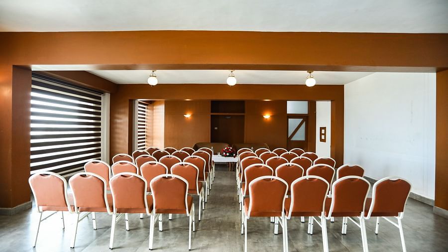 brown and white chairs placed in the banquet hall of La Montana By TGI, Ooty