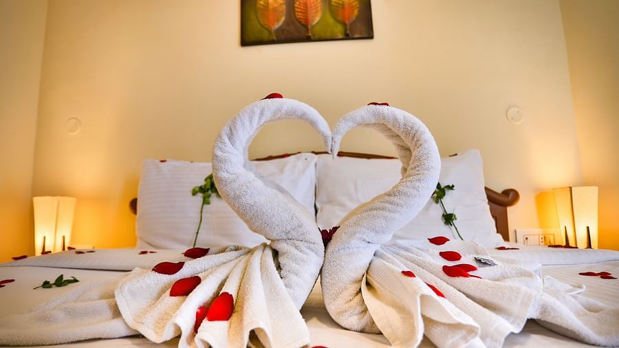 two swans made of towel are placed on a bed at La Montana By TGI, Ooty