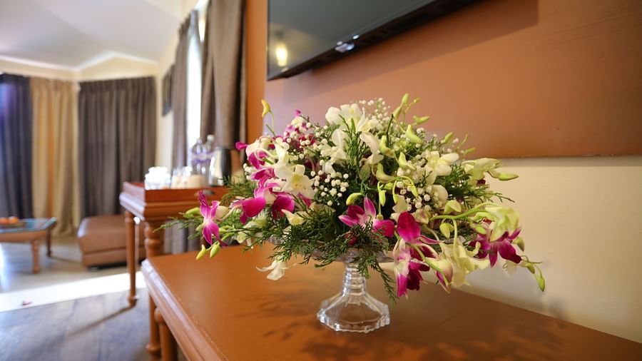 a glass vase placed with flowers at La Montana By TGI, Ooty
