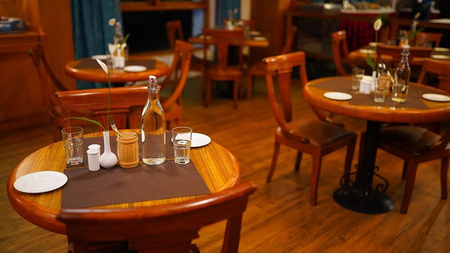 a view of dining table featuring clear plates and water bottles at La Montana By TGI, Ooty
