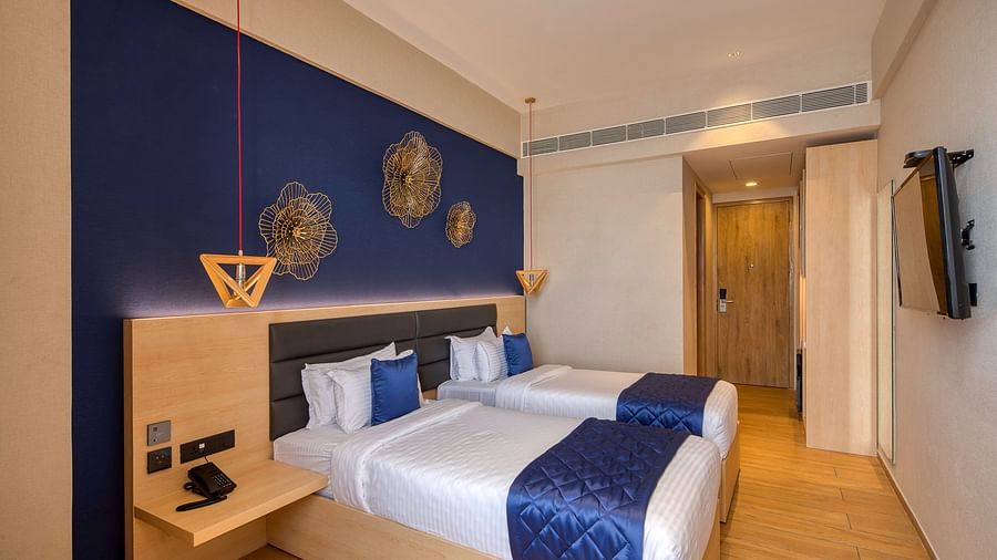 Twin beds with blue bedsheets and pillow covers at Executive Room at Le Foliage by TGI, Bangalore 2