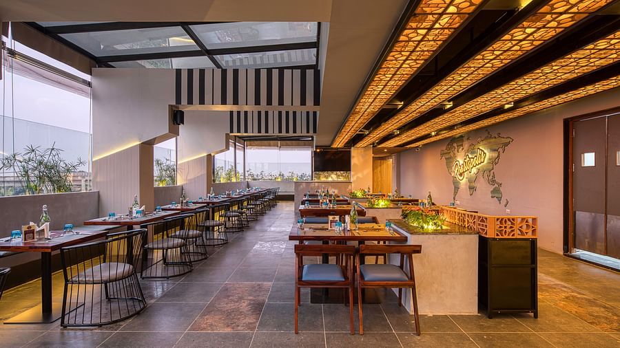 Interior of Roastopolis Restaurant at Le Foliage by TGI, Bangalore with tables and chairs