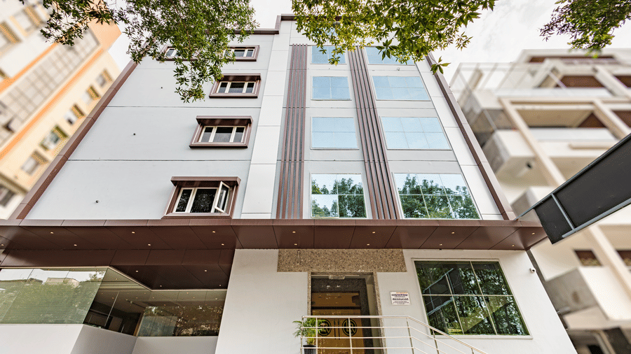 Exterior shot of the Lemonridge Hotels building with glass façade at IDPL Balanagar.