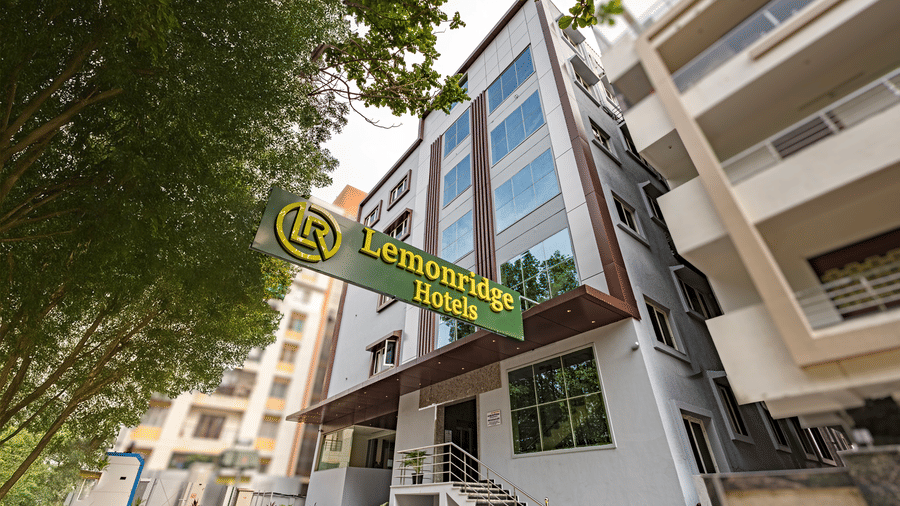Front view of Lemonridge Hotels building with green signage at IDPL Balanagar.