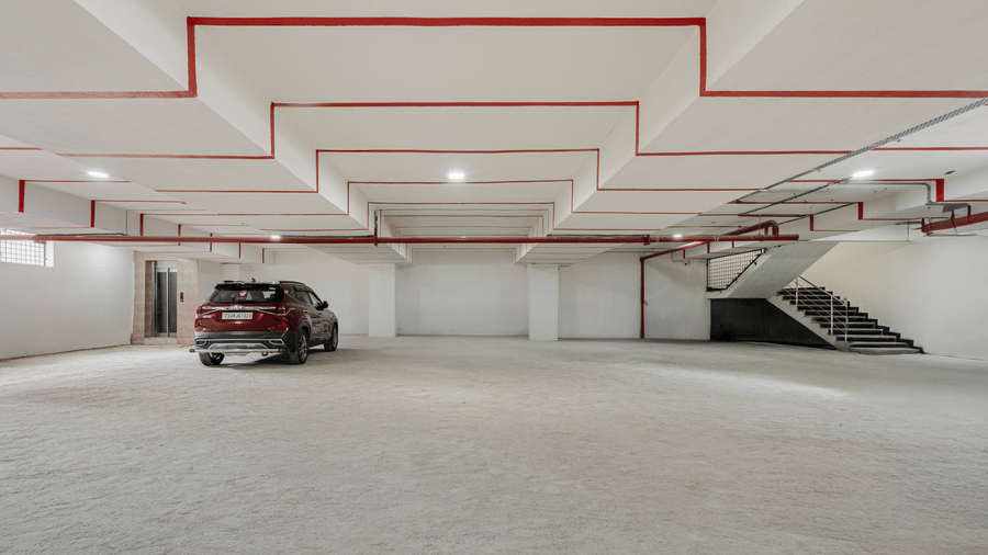 Underground parking area with marked bays at Lemonridge Hotels, IDPL Balanagar.