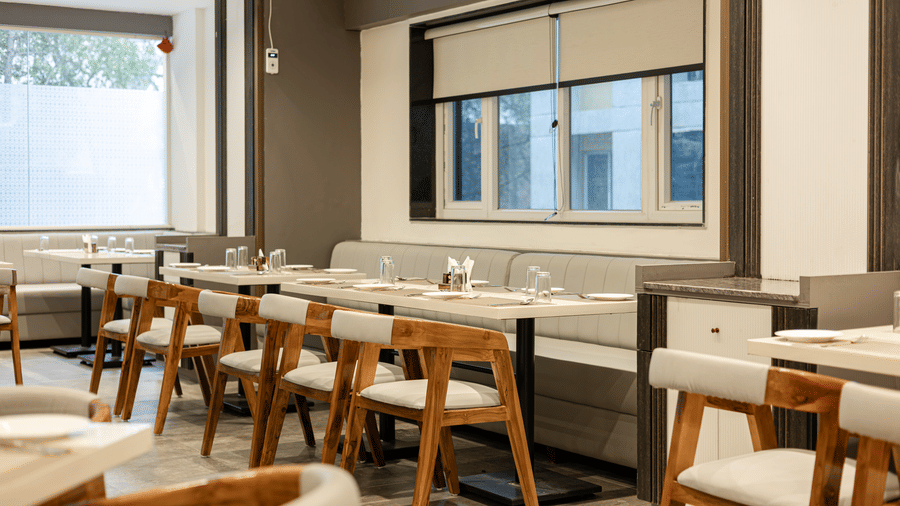 Cosy dining corner with natural light and wooden decor at Lemonridge Hotels, IDPL Balanagar