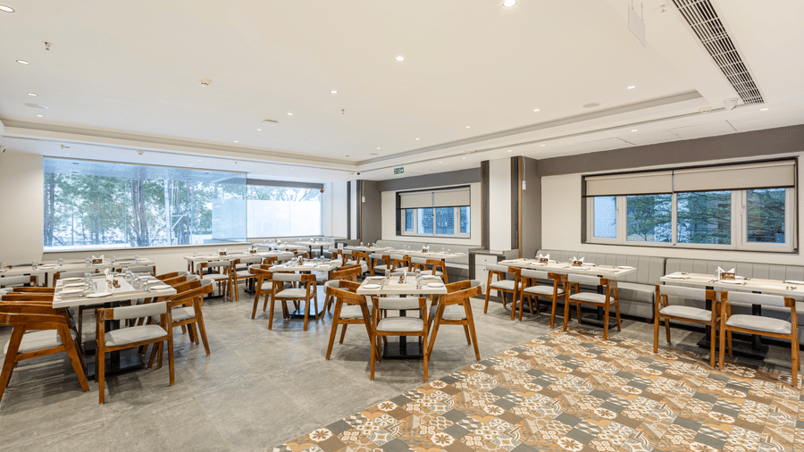 Wide-angle view of the elegant dining space with patterned flooring at Lemonridge Hotels, IDPL Balanagar.