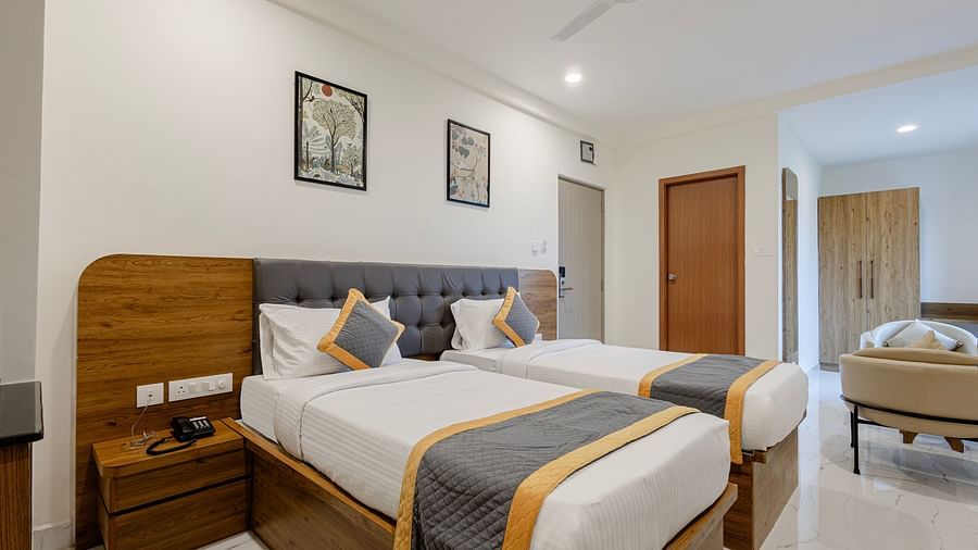 Neatly arranged double bed and workstation in a guest room at Lemonridge Hotels, IDPL Balanagar.