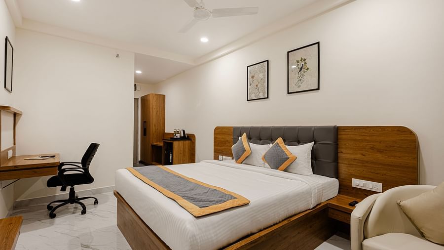 A corner view of cosy bedroom with sleek interiors at Lemonridge Hotels, IDPL Balanagar