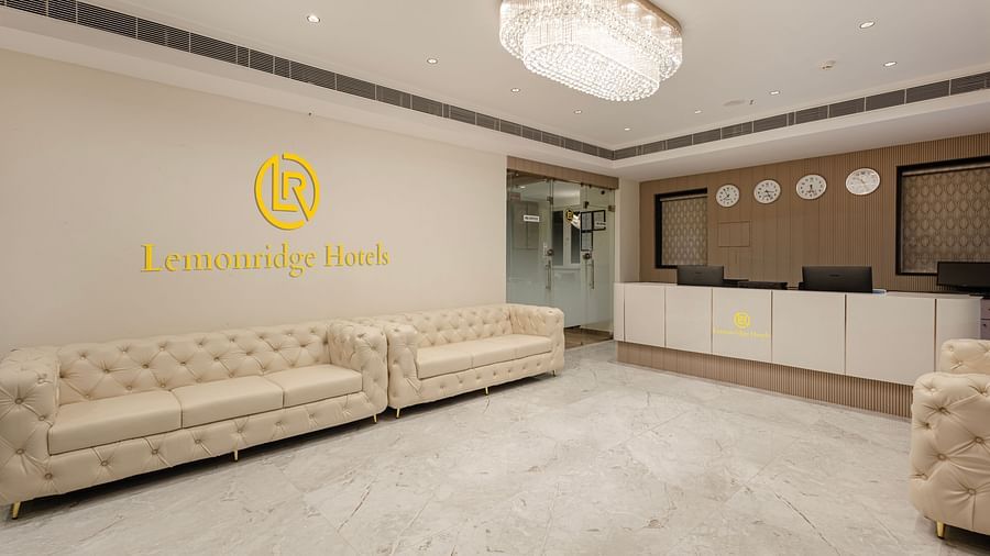 Reception lounge with white sofas and Lemonridge Hotels logo at IDPL Balanagar.