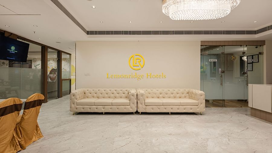 Spacious hotel lobby with chandeliers and Lemonridge branding at IDPL Balanagar.