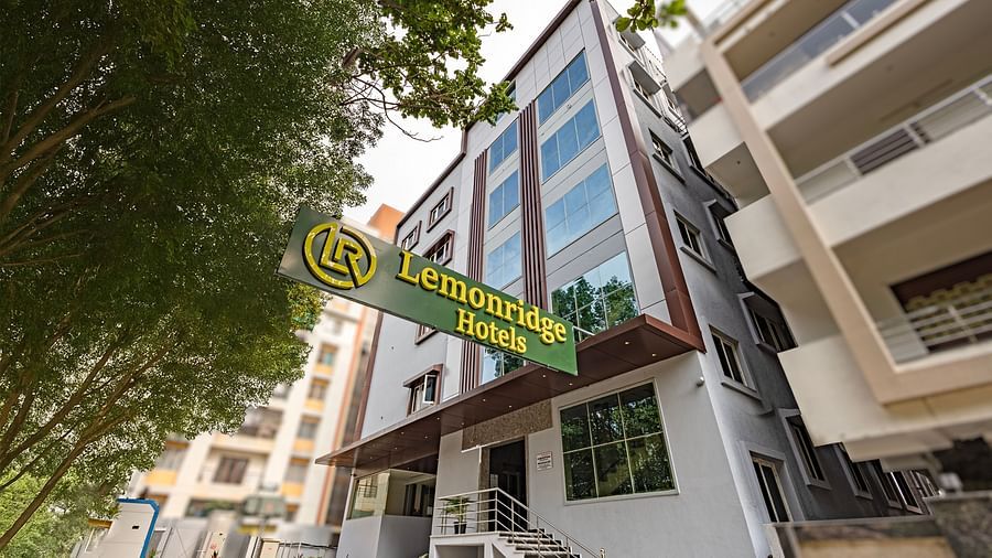 Front view of Lemonridge Hotels building with green signage at IDPL Balanagar.