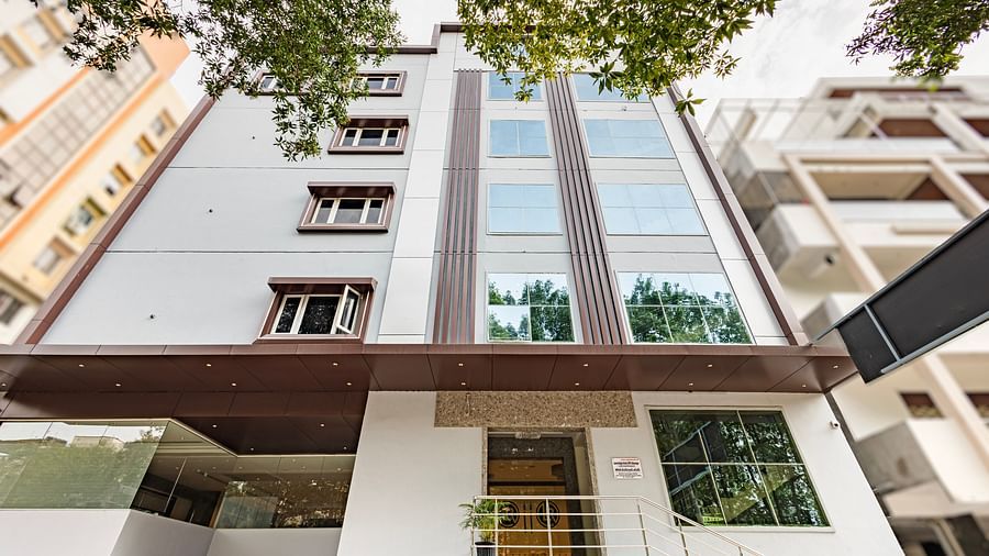 Exterior shot of the Lemonridge Hotels building with glass façade at IDPL Balanagar.
