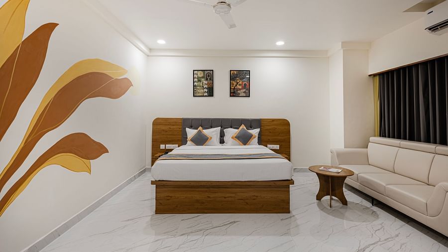 Corner view of a premium room with sofa, artwork, and ambient lighting at Lemonridge Hotels, IDPL Balanagar.