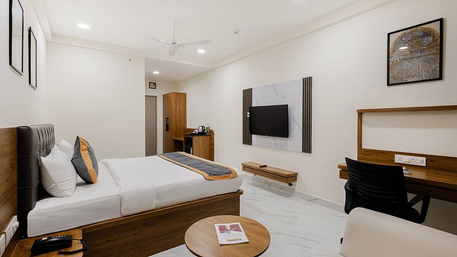 Premium room featuring cosy seating, writing desk, and double bed at Lemonridge Hotels, IDPL Balanagar.