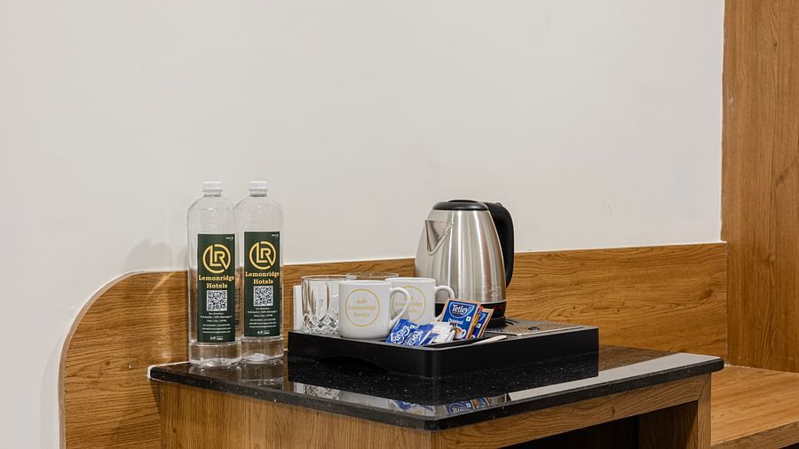 In-room tea and coffee setup with bottled water at Lemonridge Hotels, IDPL Balanagar.