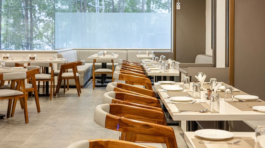 A close view of the modern dining space with natural light at Lemonridge Hotels, IDPL Balanagar