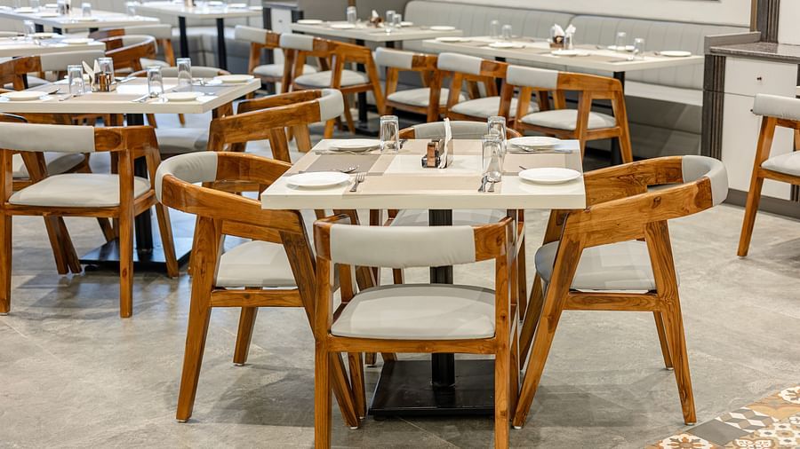 Wooden seating and sleek arrangement in the restaurant at Lemonridge Hotels, IDPL Balanagar
