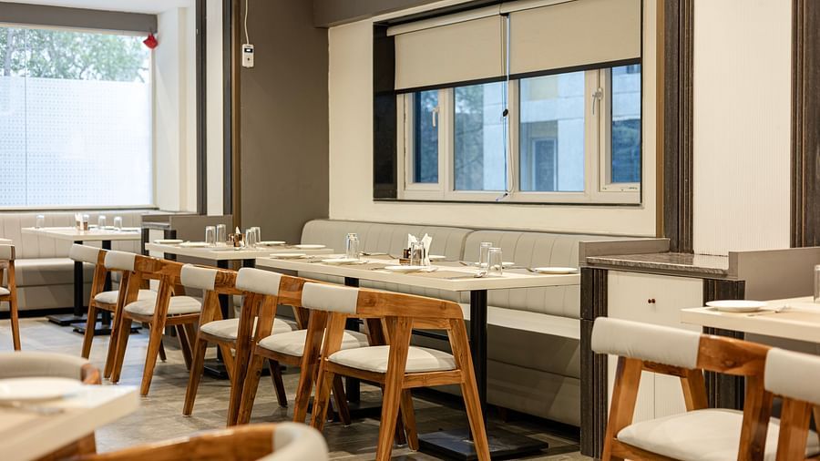 Cosy dining corner with natural light and wooden decor at Lemonridge Hotels, IDPL Balanagar