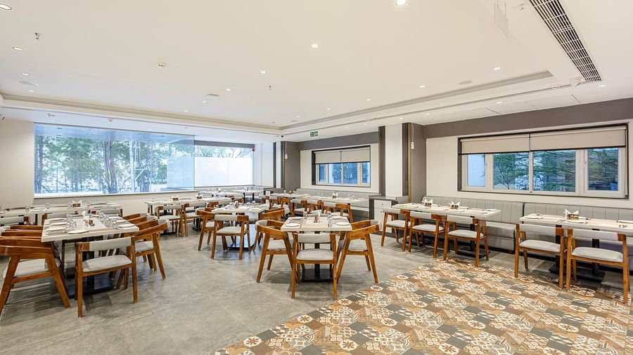 Wide-angle view of the elegant dining space with patterned flooring at Lemonridge Hotels, IDPL Balanagar.