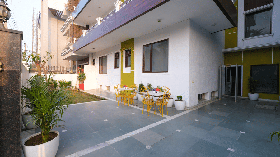 Multiple storey building exterior of Lime Tree Hotels & Service Apartment Private Limited featuring a paved driveway and potted plants.