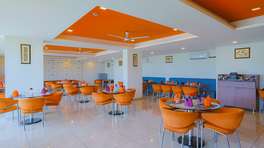 Extended view of Cafe Treat at Livbox, Dehradun, featuring multiple dining tables arranged spaciously.