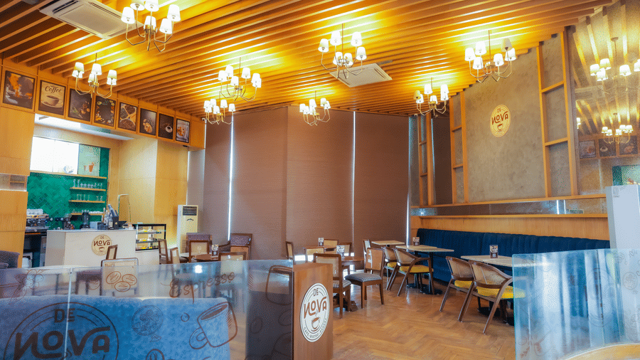 Cosy dining area with golden lighting and a relaxed atmosphere at Livbox Supernova cafe.