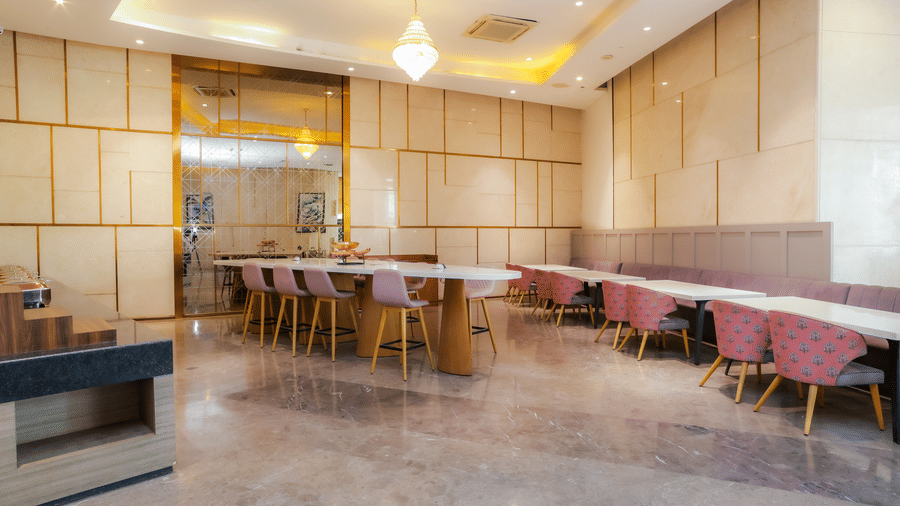 Spacious restaurant seating at Livbox Supernova, featuring contemporary interiors with comfortable chairs and wall art.