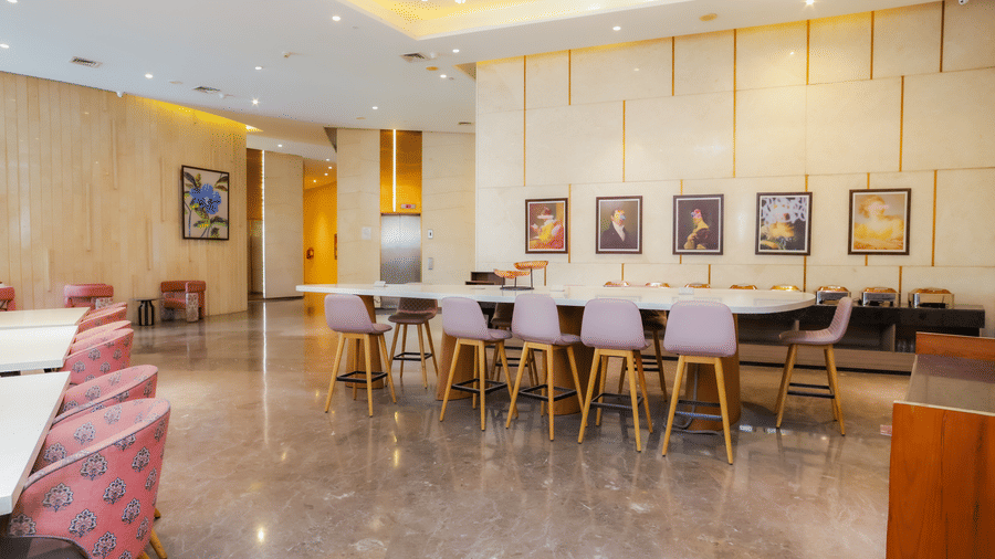 Elegant dining area at Livbox Supernova, Noida, with modern decor, wooden tables, and soft lighting.