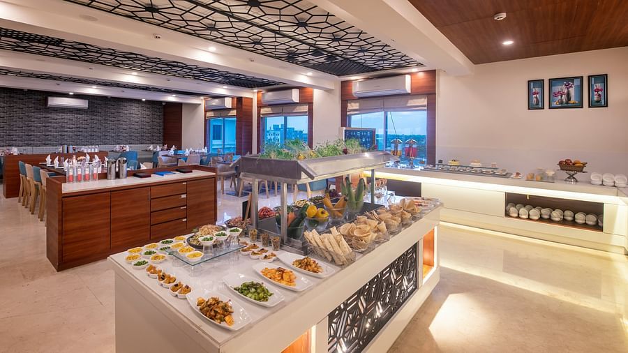 Restaurant buffet spread showcasing a variety of dishes on modern counters - Lords Eco Inn Shapar Rajkot
