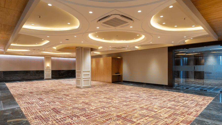 Spacious banquet hall with elegant lighting for events at Lords Inn Sanand Gujarat.