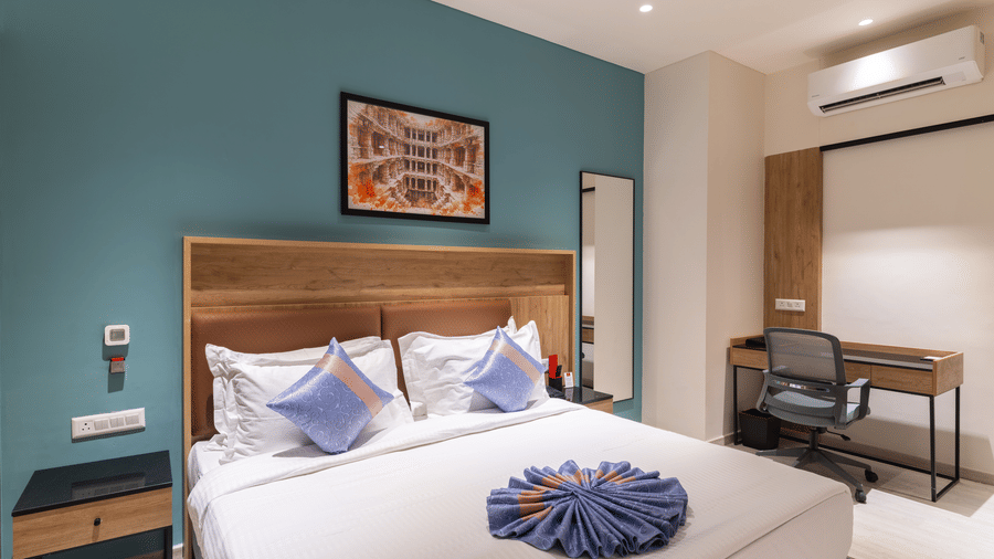 Comfortable king bedroom with workspace and contemporary décor at Lords Inn Sanand Gujarat.