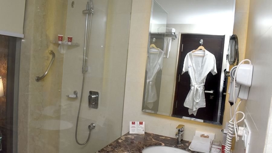 A modern bathroom with a shower and sink area at Lords Plaza Surat.