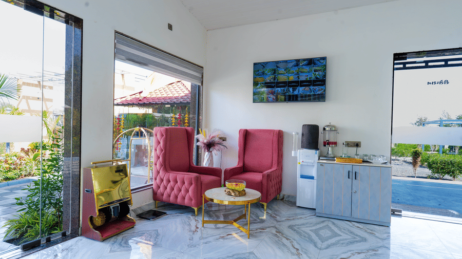 Stylish indoor seating area with pink chairs and modern decor at Lords SKD Resort, Salangpur.