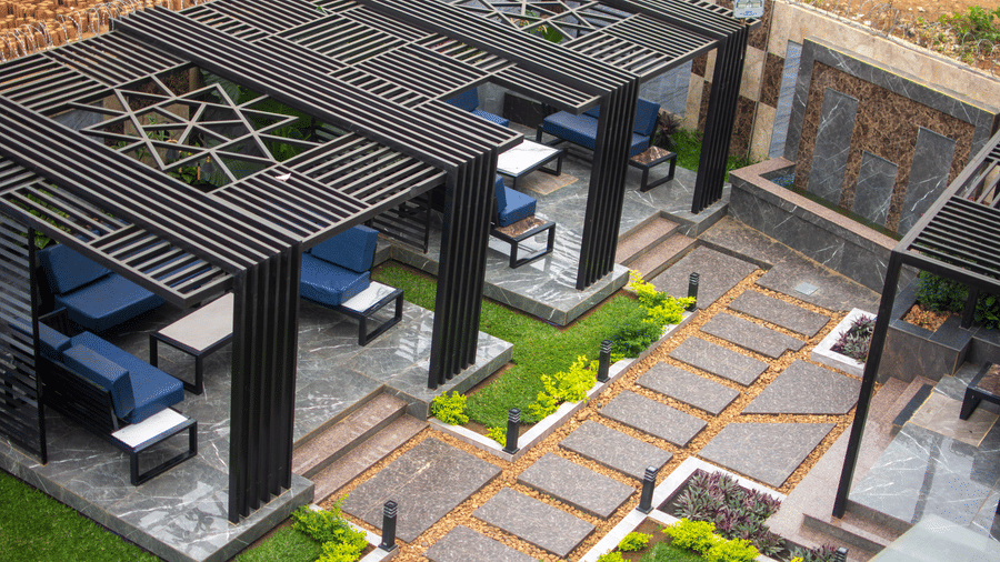 Outdoor seating area with covered pergolas on a paved patio - Luffu Club