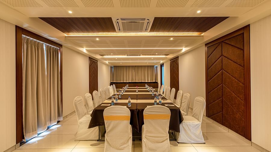 Image of a boardroom featuring a table surrounded by chairs at M Pro Palace.